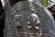 Sri Lanka: An hour glass and the skull and crossbones decorate a gravestone in the Dutch Reformed Church cemetery, Fort District, Galle